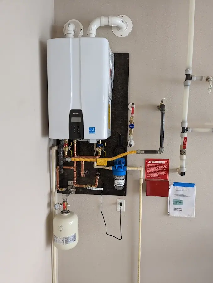Professional plumber installing copper piping in a Upper Moreland home
